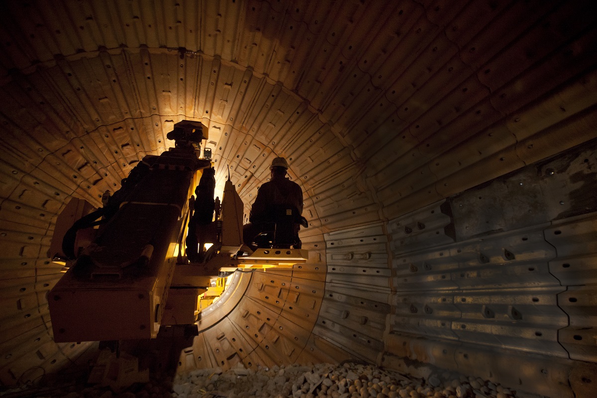 A RUSSELL Mill Relining Machine and operator inside a darkened SAG mill