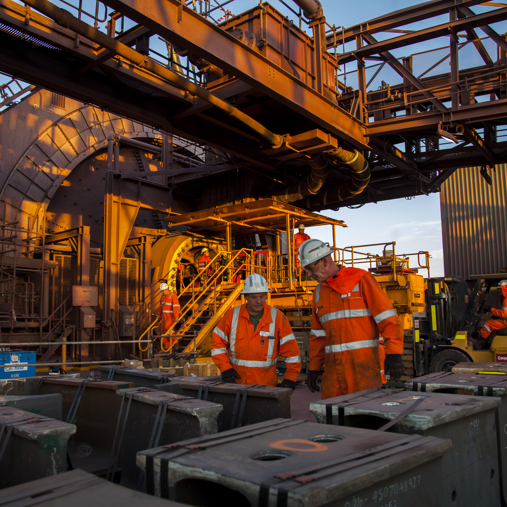Two mill relining crew members looking at a SAG mill