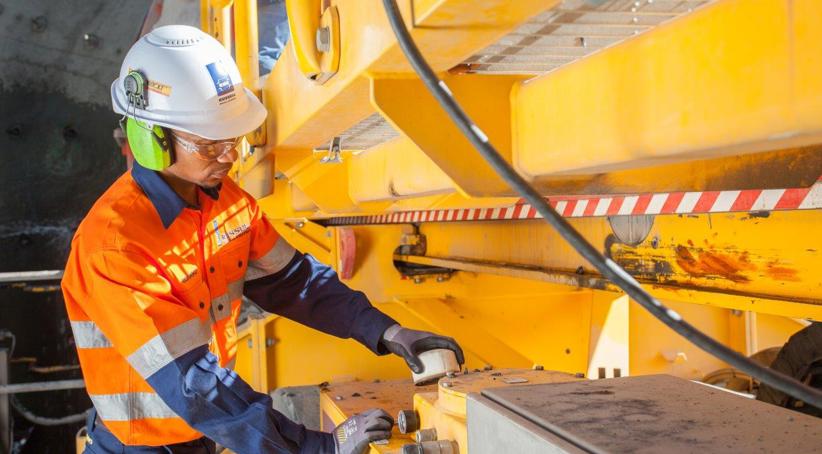 An African RME Customer Service Technician inspecting a RUSSELL Mill Relining Machine