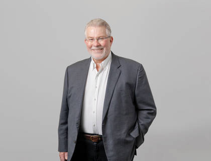 Dr John Russell  - $Founder and Director