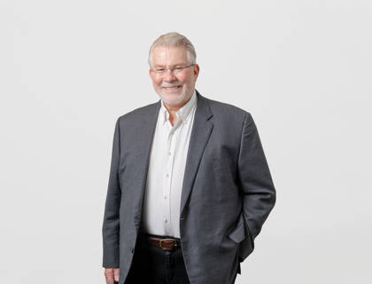 Dr John Russell  - $Founder and Director